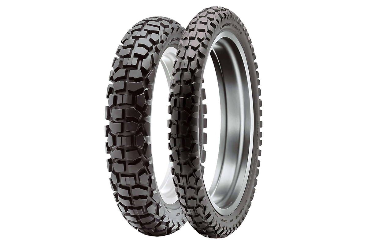 Dunlop D605: front and rear pair standing side by side and overlapping on white, the blockier rear at left and the front at right with D605F moulded in the sidewall