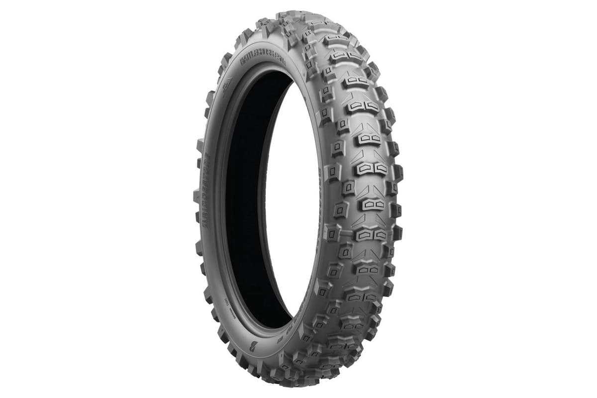 Bridgestone Battlecross E50 rear tire, three-quarter view showing the BATTLECROSS E50 R sidewall and tall knobs, on white