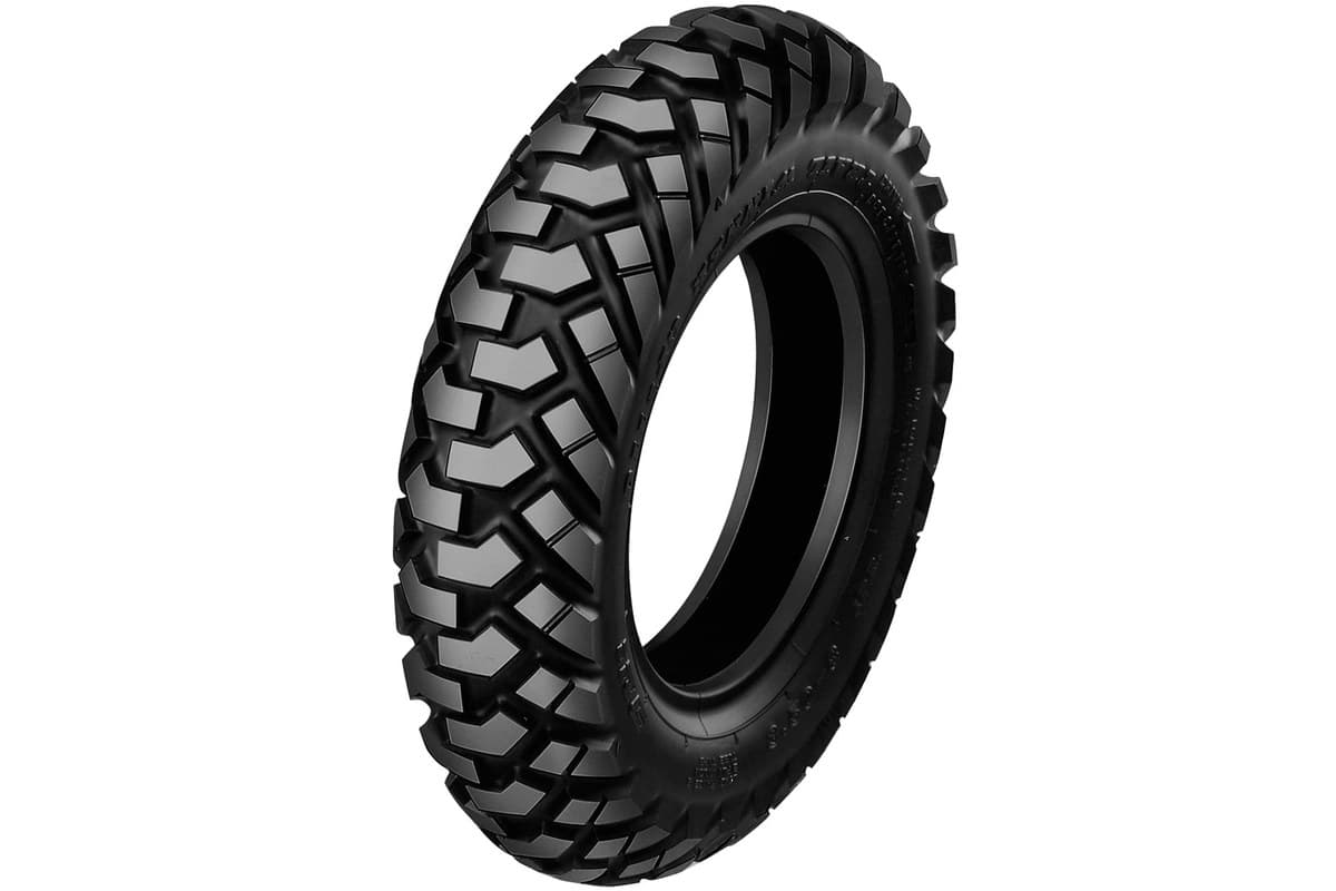 IRC GP-110: a single tire in three-quarter view, bare with no rim, the chevron tread and moulded sidewall lettering visible, on white