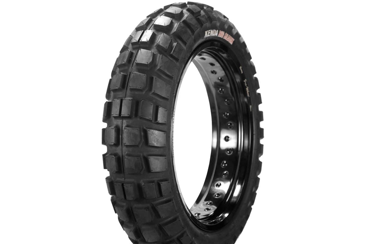 Kenda Big Block K784: rear tire mounted on a gloss black spoked rim, cropped tight, with the moulded red and white sidewall branding visible