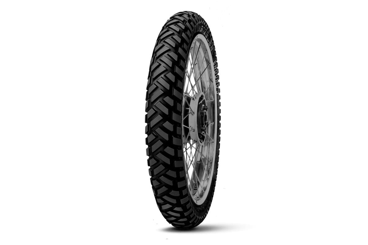 Metzeler Enduro 3 Sahara: the front alone on a spoked wheel, turned nearly head-on to show the tread blocks