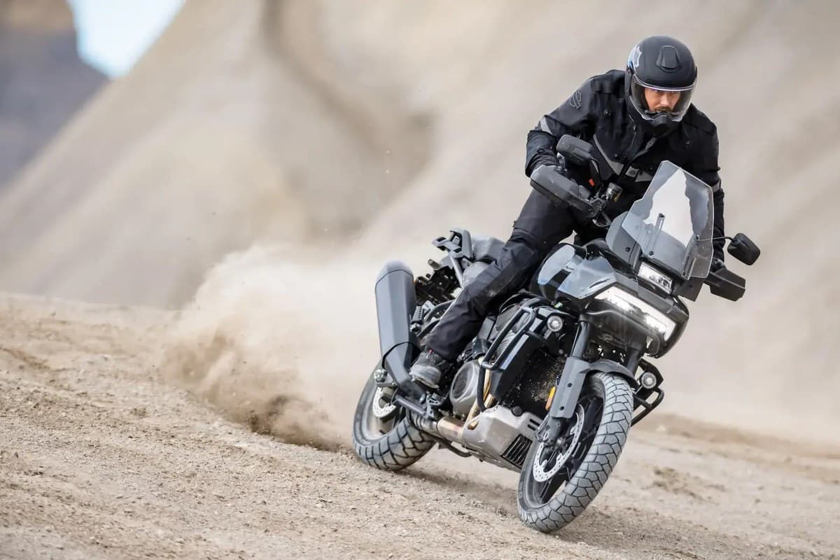 Michelin Scorcher Adventure: a rider on a Harley-Davidson Pan America kicking up dust on a sandy track
