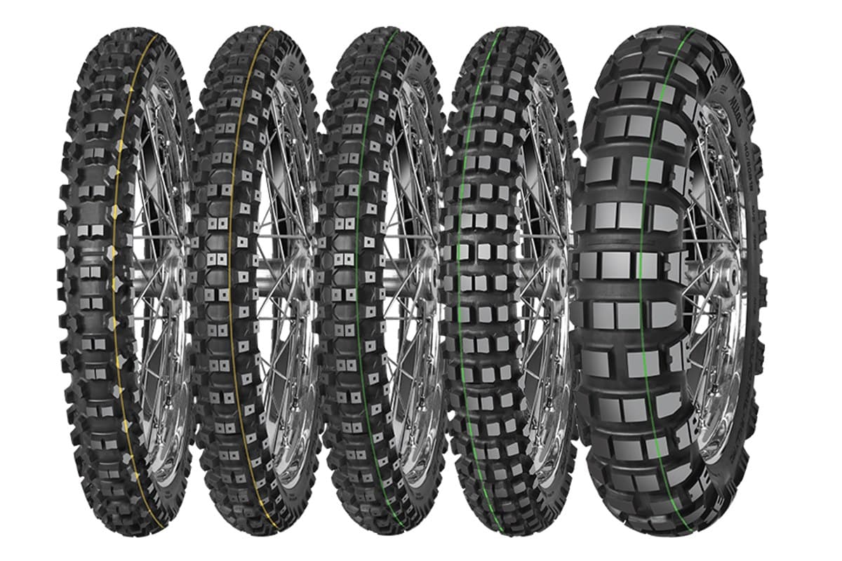 Mitas Enduro Trail-Rally: the whole line side by side, four fronts (two with yellow stripes, two with green) and the wider green-stripe rear at right