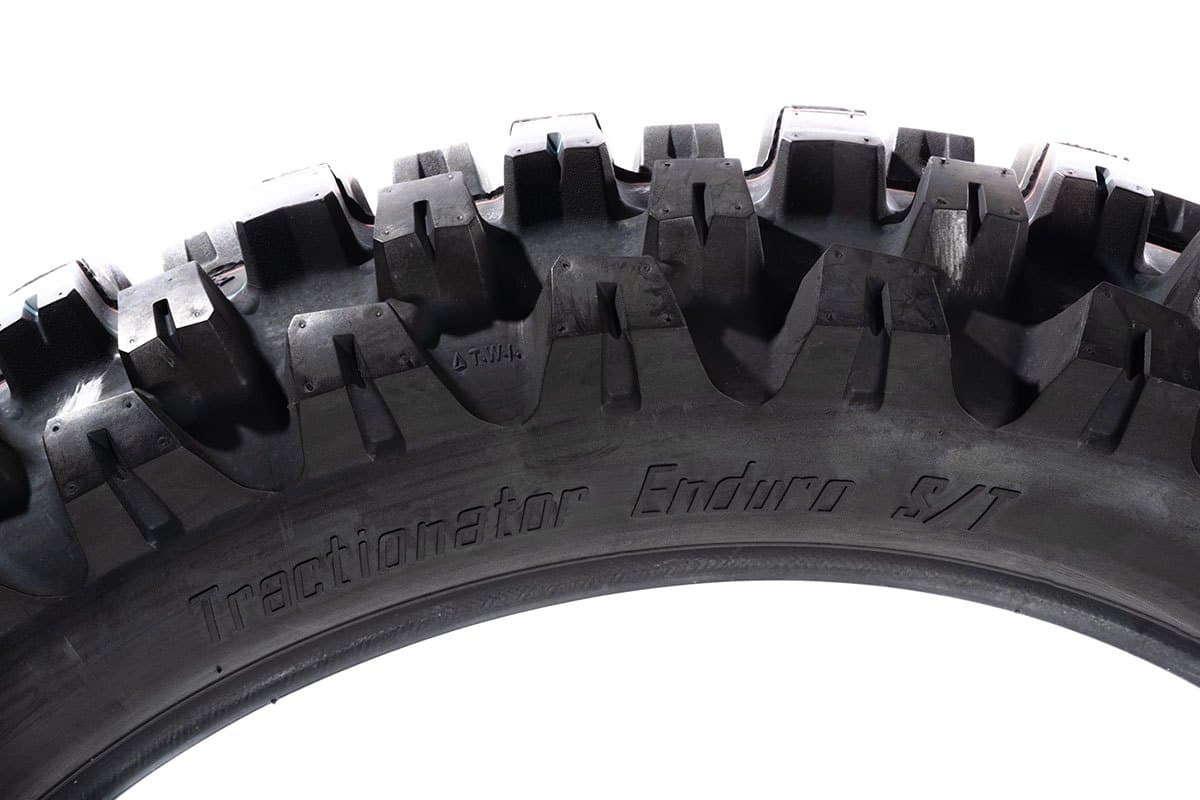 Motoz Tractionator Enduro S/T: side-on view of the tread arc, knob silhouette, with the model name moulded in the sidewall