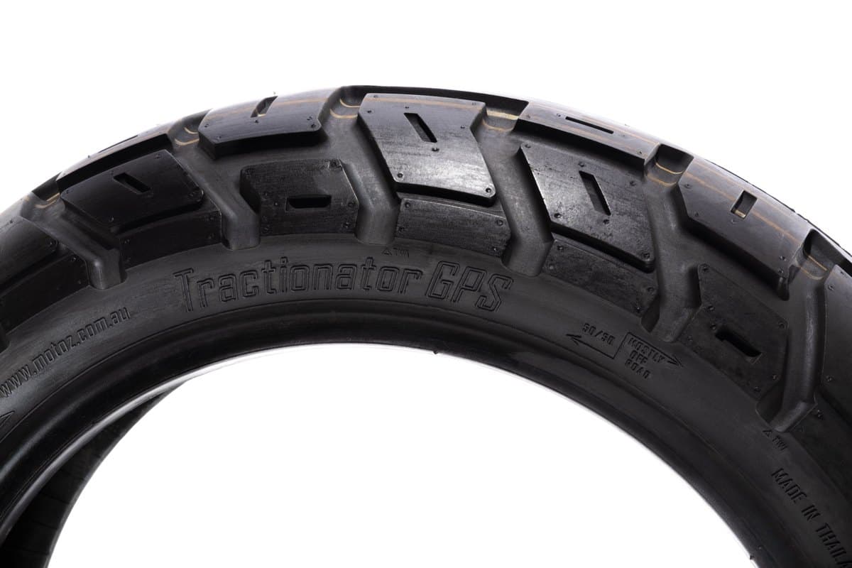 Motoz Tractionator GPS: sidewall and shoulder edge on, with the model name and rotation marking moulded into the rubber