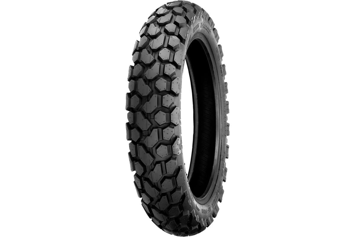 Shinko 700 Series Dual Sport: rear tire, same angle, much wider and squatter with the hexagonal blocks spread across a broad crown