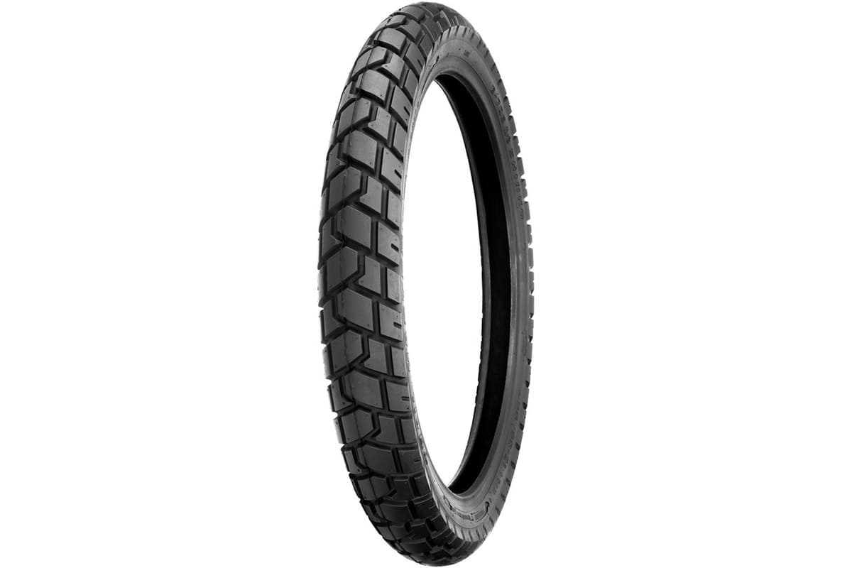 Shinko 705 Series Dual Sport: front tire, three-quarter studio view on white, narrow carcass with a street-biased chevron tread