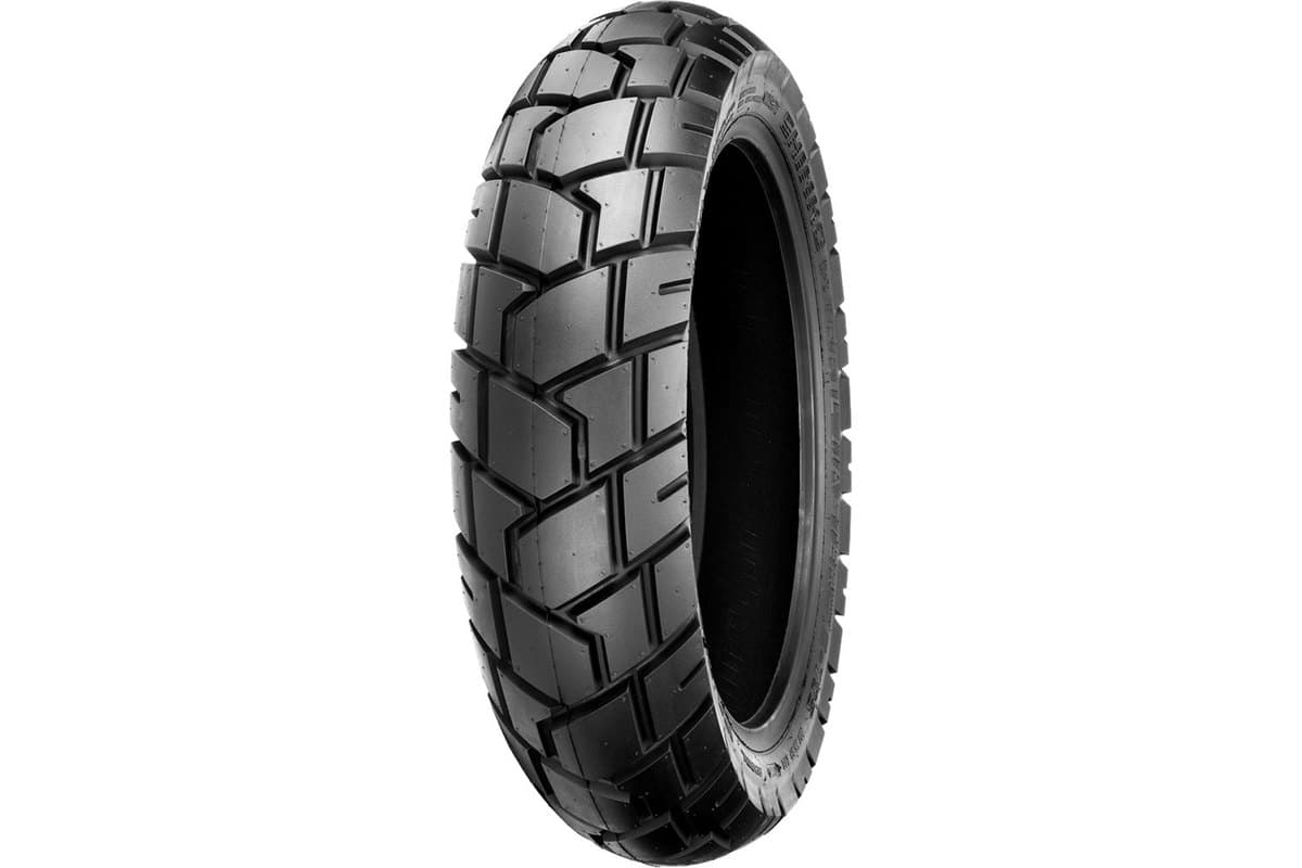 Shinko 705 Series Dual Sport: rear tire, same studio angle, visibly fatter with wider blocks and a flatter centre band