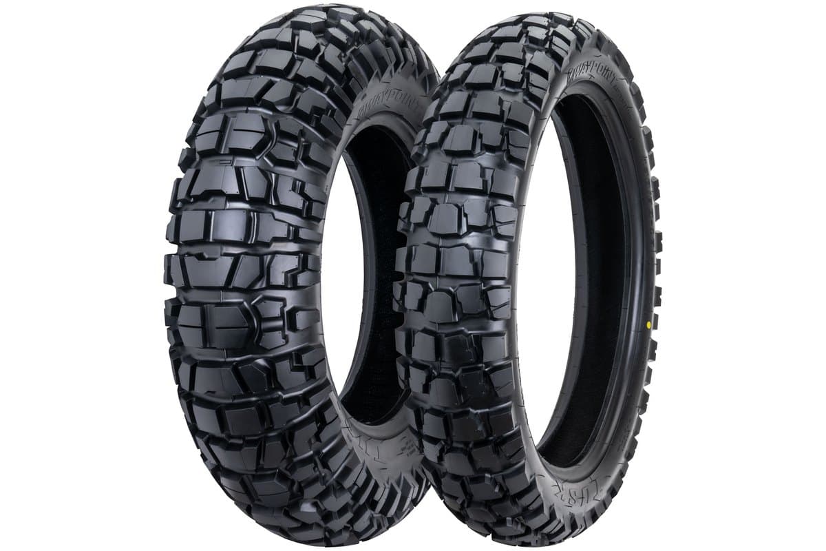 Tusk Waypoint Adventure: a small-diameter front and rear pair rotated toward the camera so the whole tread face of each is visible rather than the sidewall