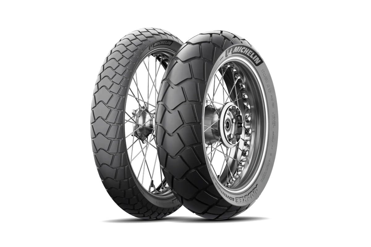 Michelin Anakee Adventure 2: front and rear pair on silver spoked wheels, three-quarter view, showing the second-generation chevron and block pattern
