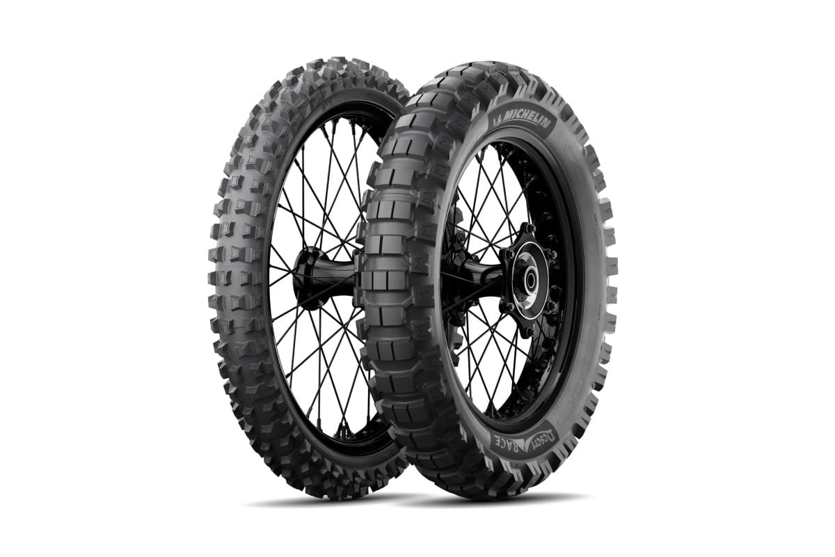Michelin Desert Race: front and rear knobby pair on black spoked dirt wheels, three-quarter view, with the model name on the rear sidewall