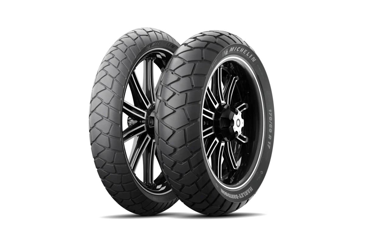 Michelin Scorcher Adventure: front and rear pair on black multi-spoke cast wheels, three-quarter view, MICHELIN and HARLEY-DAVIDSON on the sidewalls, on white