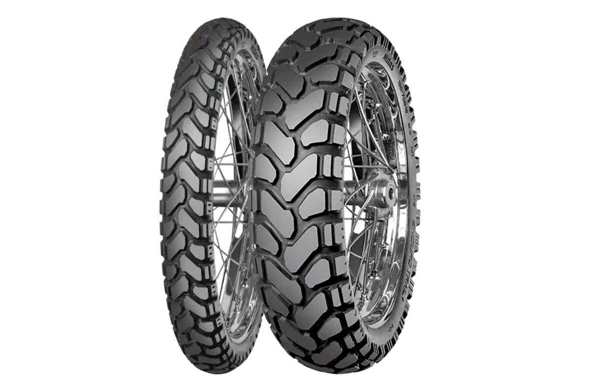 Mitas Enduro Trail+: front and rear pair on chrome spoked rims, blockier tread than the base Enduro Trail, on white