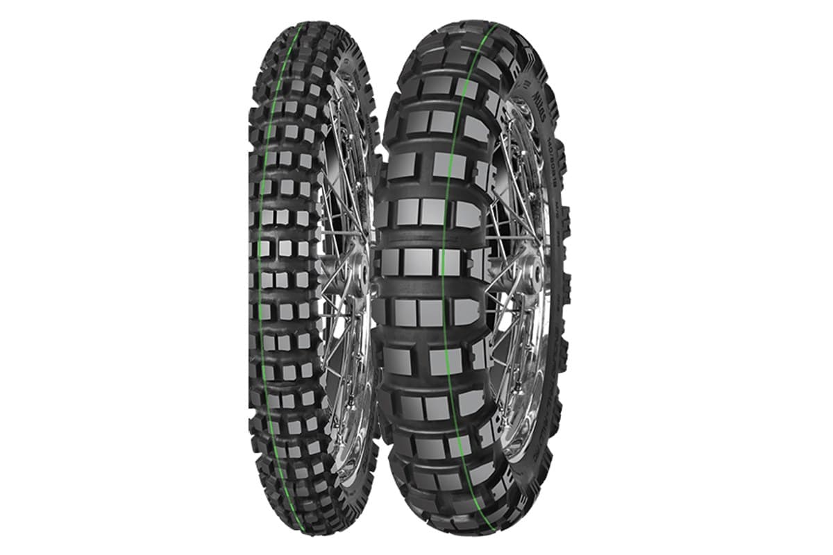 Mitas Enduro Trail-Rally: a green-stripe front and the rear on chrome spoked rims, tall square knobs, three-quarter view on white