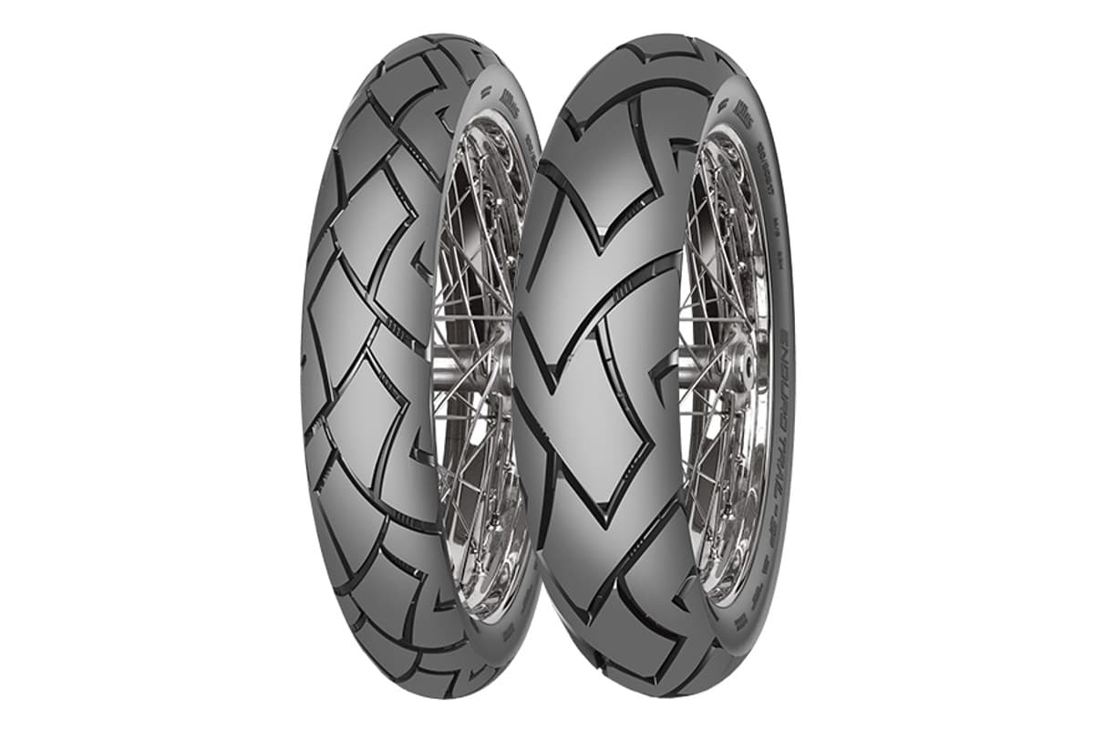Mitas Enduro Trail-SP: front and rear pair on chrome spoked rims, three-quarter view of the open road-biased tread, on white
