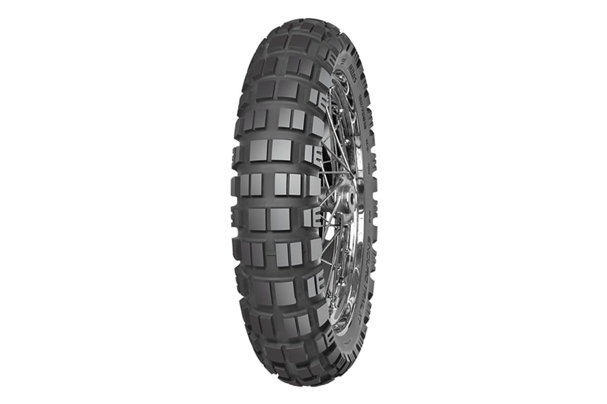 Mitas Enduro Trail-XT: a single rear tire on a chrome spoked rim, knobby block tread, three-quarter view on white. A single shot is correct, this model is rear only