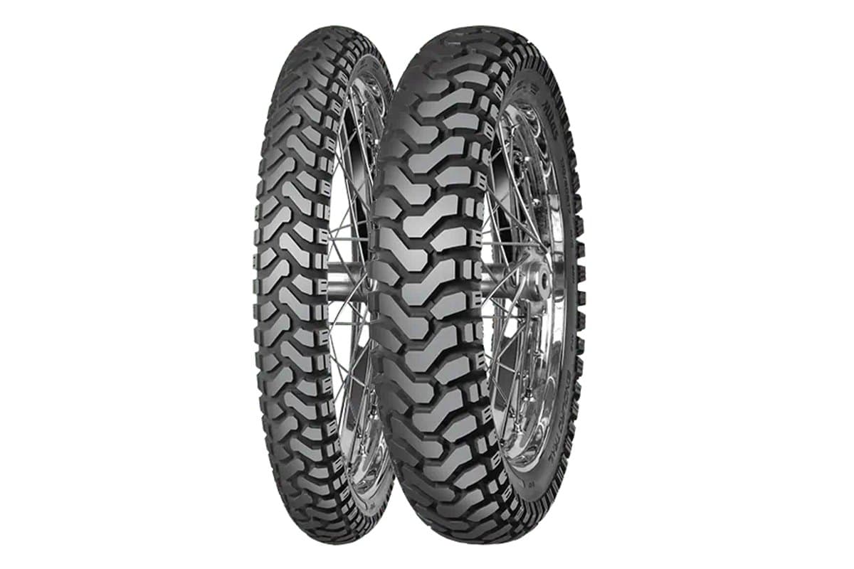 Mitas Enduro Trail: front and rear pair on chrome spoked rims, tread-facing three-quarter view on white
