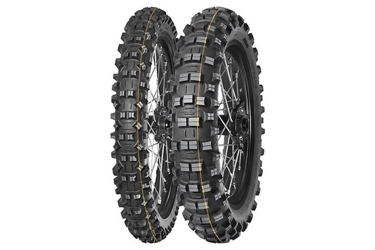 Mitas Terra Force-EF Super: front and rear pair on black spoked wheels, yellow stripe around each tread, the narrow front behind at left and the short-knob rear in front, on white