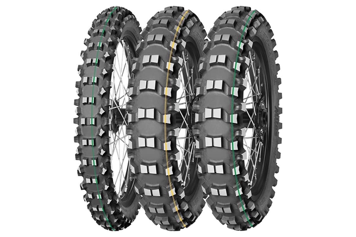 Mitas Terra Force-EX SM: three tires on spoked wheels, a green-striped Super Light front at left and two rears with yellow (Super) and green (Super Light) tread stripes, on white