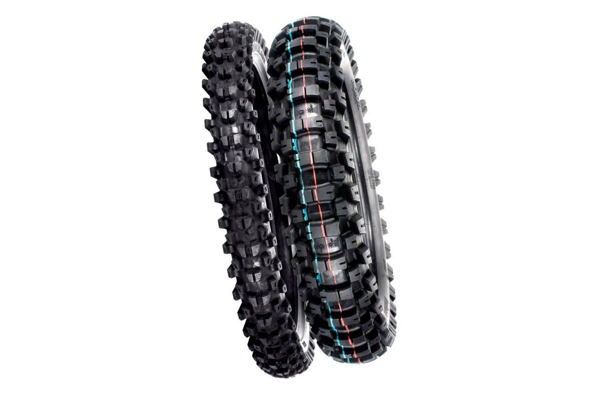 Motoz Tractionator Enduro S/T: front tire at left and rear at right overlapping, on white