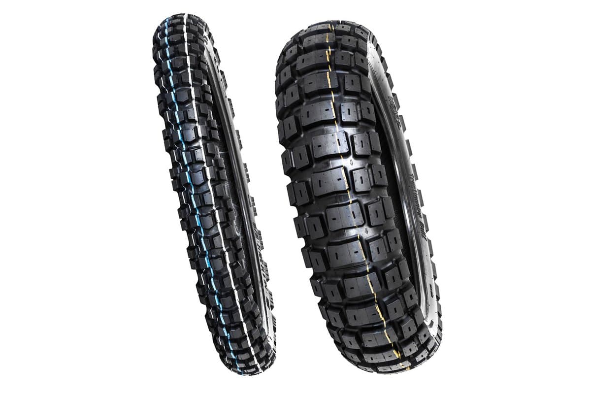Motoz Tractionator RallZ: narrow front tire at left and wide rear at right, both standing, on white