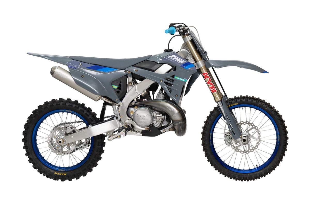 2026 TM MX 250 FI 2T motocross bike in gunmetal grey with blue accents, right-side studio profile showing the KYB forks and blue Excel rims