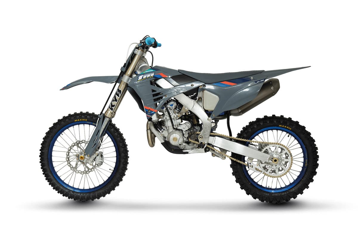 2026 TM MX 250 ES Fi 4T in TM's grey and blue race livery, studio side profile on a white background