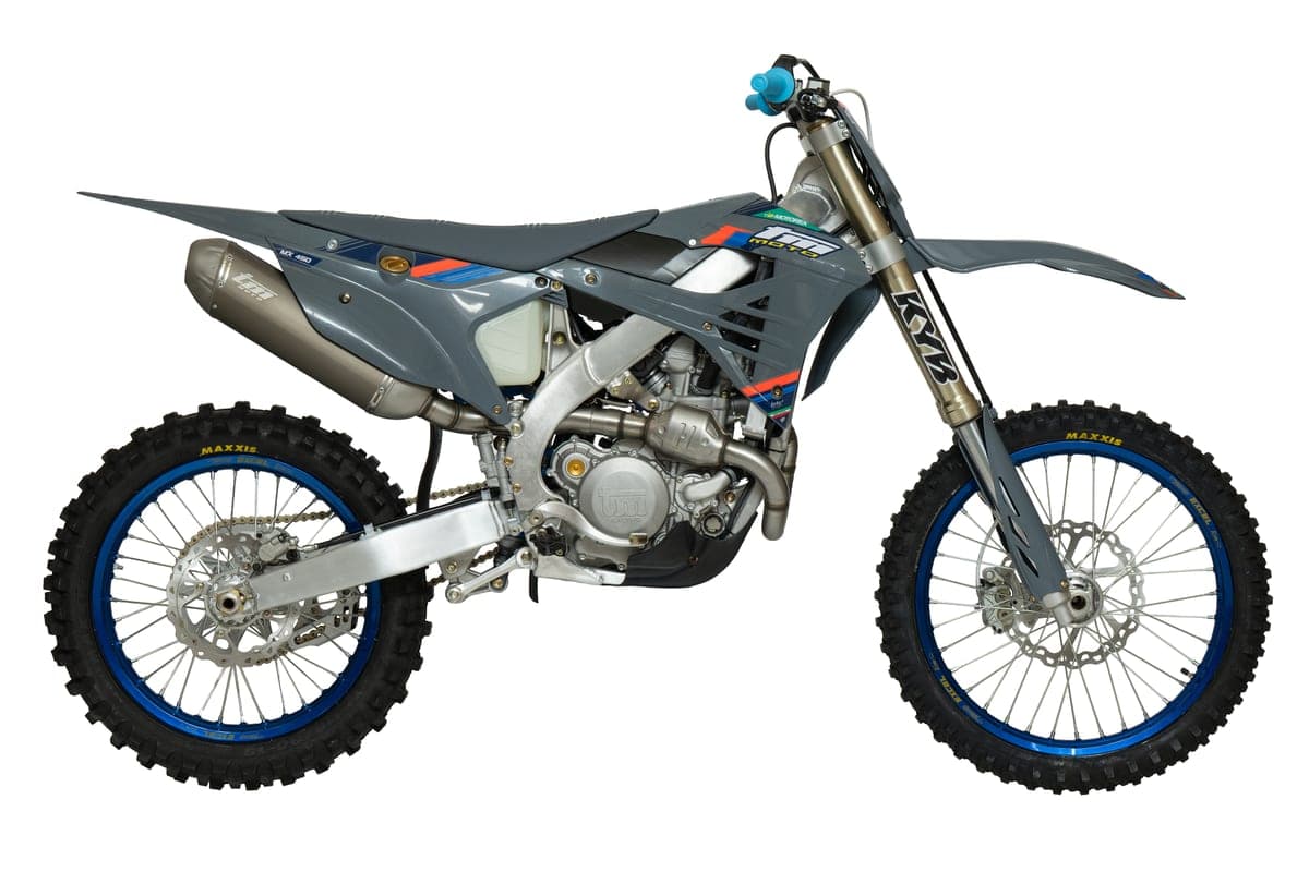 2026 TM MX 450Fi 4T motocross bike in grey with blue accents, right-side studio profile showing the KYB fork, blue Excel rims and titanium exhaust