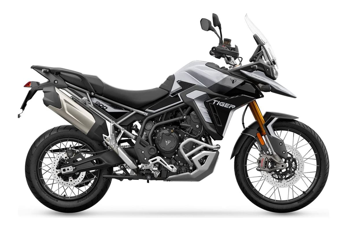 2026 Triumph Tiger 900 Rally Pro adventure motorcycle in black and white, right-side studio profile showing the spoked wheels, gold-anodized forks and tall windscreen