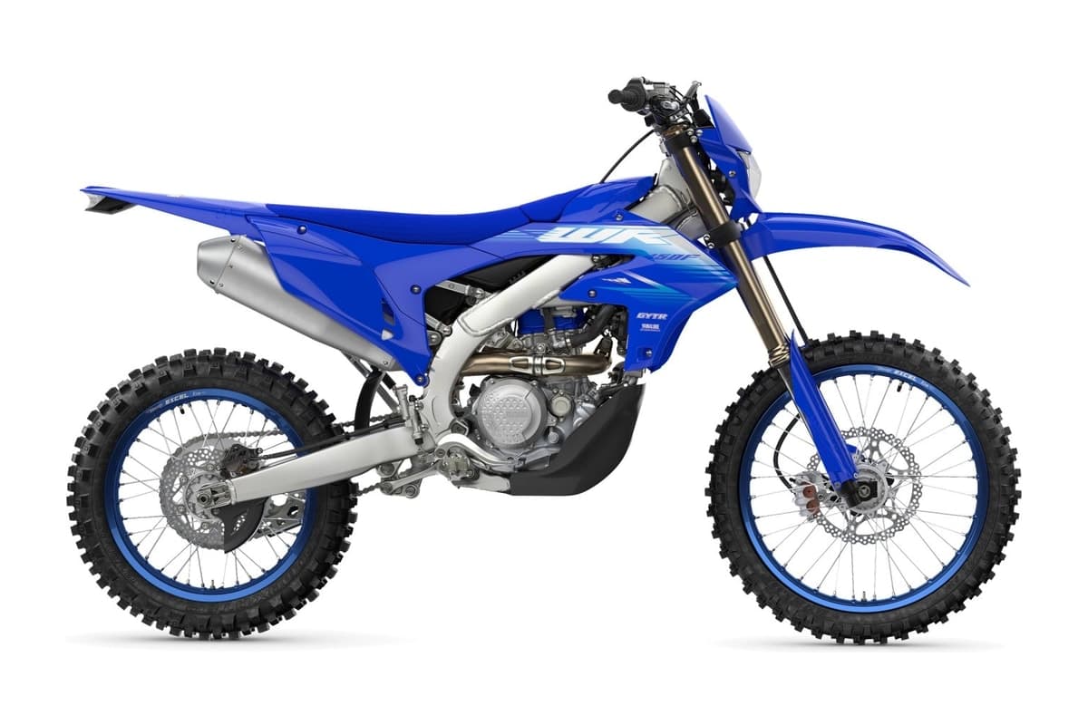 2027 Yamaha WR450F enduro in blue, right-side studio profile of the redesigned bike showing its YZ450F-derived aluminum frame, blue-rimmed spoked wheels and exhaust