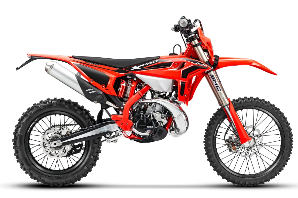 2027 Beta 200 RR X-Pro dual-sport enduro in red and black, right-side studio profile showing the chrome silencer, inverted forks and X-Pro graphics