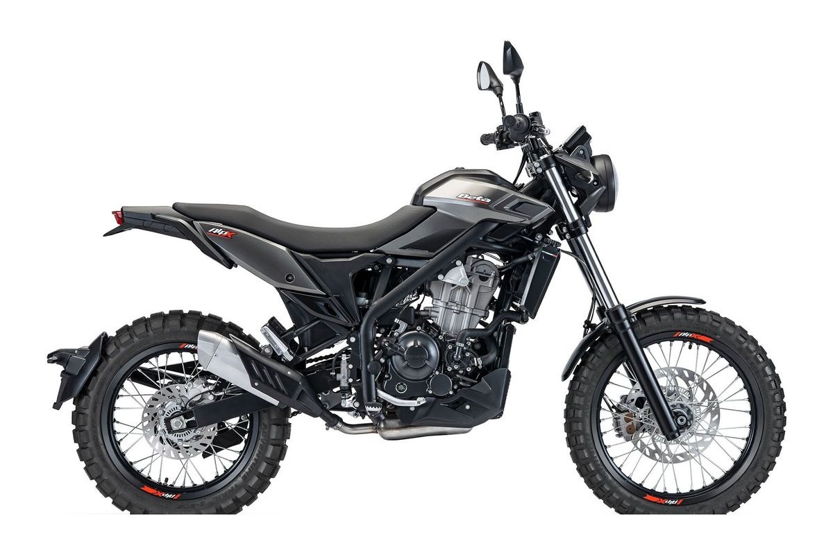 2026 Beta Alp X dual-sport motorcycle in matte black, left-side studio profile showing the trellis frame, spoked wheels and knobby tires