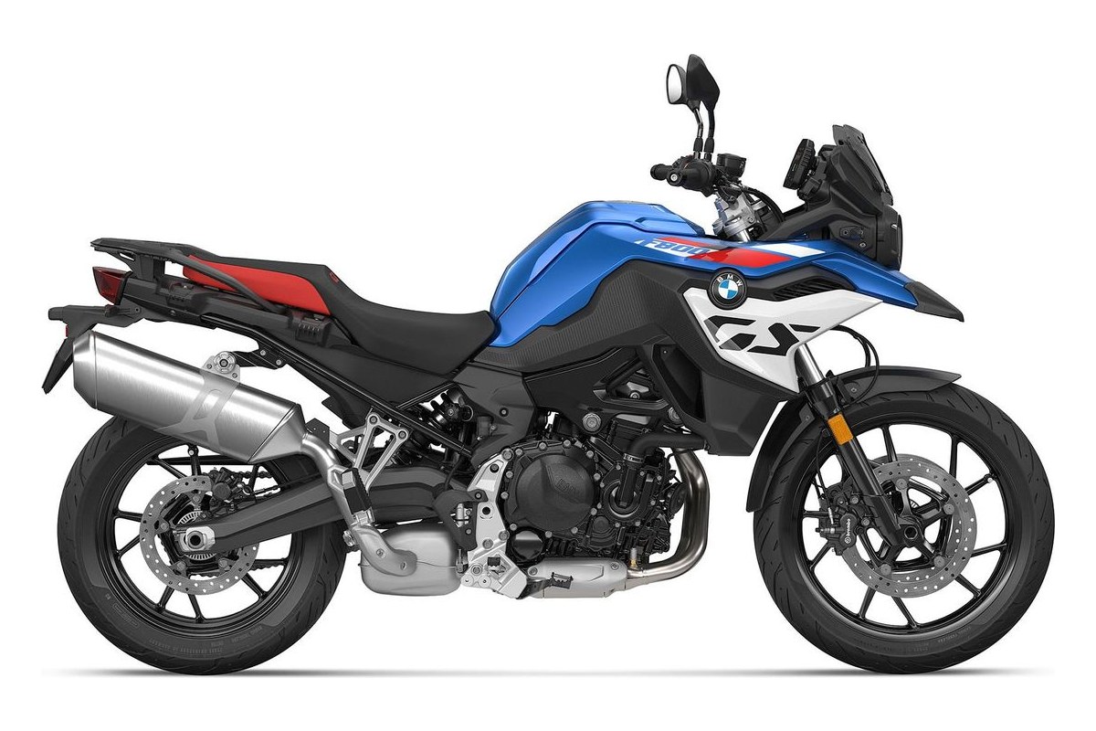 2027 BMW F 800 GS adventure motorcycle in white with blue seat accents, left-side studio profile showing the aluminum exhaust and spoked-look cast wheels