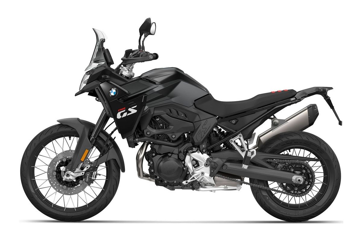 2027 BMW F 900 GS adventure motorcycle in blue and black, right-side studio profile showing spoked wheels, Akrapovic-style exhaust and tall windscreen
