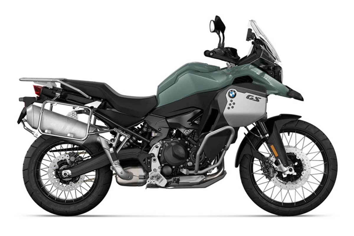 2027 BMW F 900 GS Adventure in sage green and silver, right-side studio profile with spoked wheels, aluminum panniers and tall windscreen