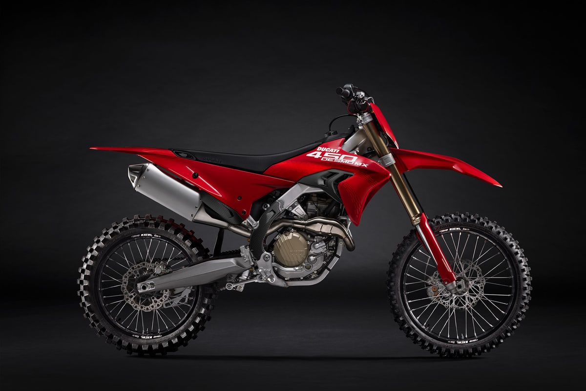 2026 Ducati Desmo450 MX motocross bike in red and black, right-side studio profile showing gold KYB fork legs and Excel spoked wheels
