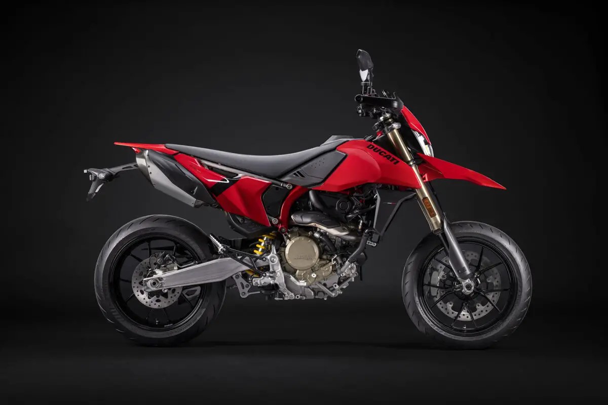 2026 Ducati Hypermotard 698 Mono in red and black, right-side studio profile showing gold-anodized forks, exposed trellis-style subframe and supermoto wheels