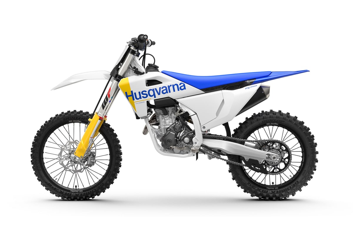 Husqvarna FC 250 left-side studio profile showing the chain, sprocket and exhaust header under the engine