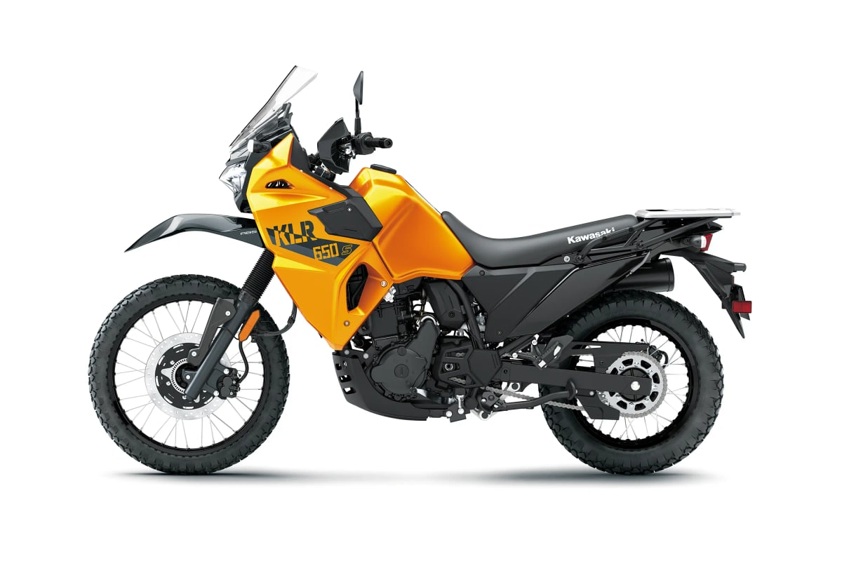 Kawasaki KLR650 S left-side studio profile in yellow, showing the chain, rear shock and exhaust