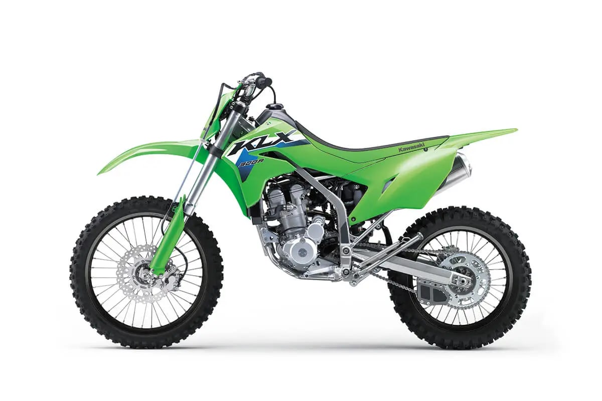 Kawasaki KLX300R left-side studio profile in Lime Green, showing the chain, Uni-Trak shock reservoir and exhaust routing