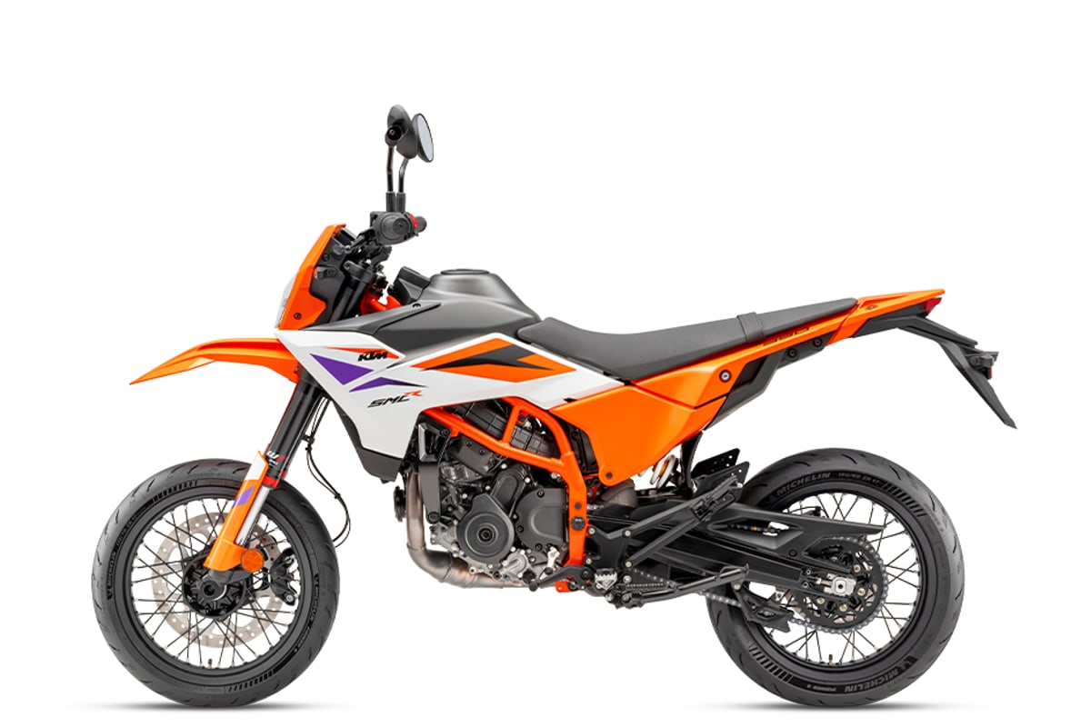 KTM 390 SMC R left-side studio profile showing the chain, split-piston shock and silencer