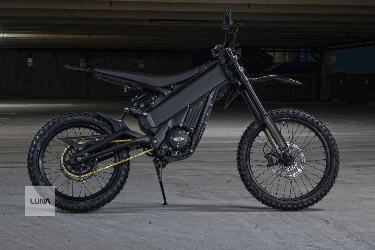 Talaria xXx Pro in black, left-side view photographed in a concrete parking structure