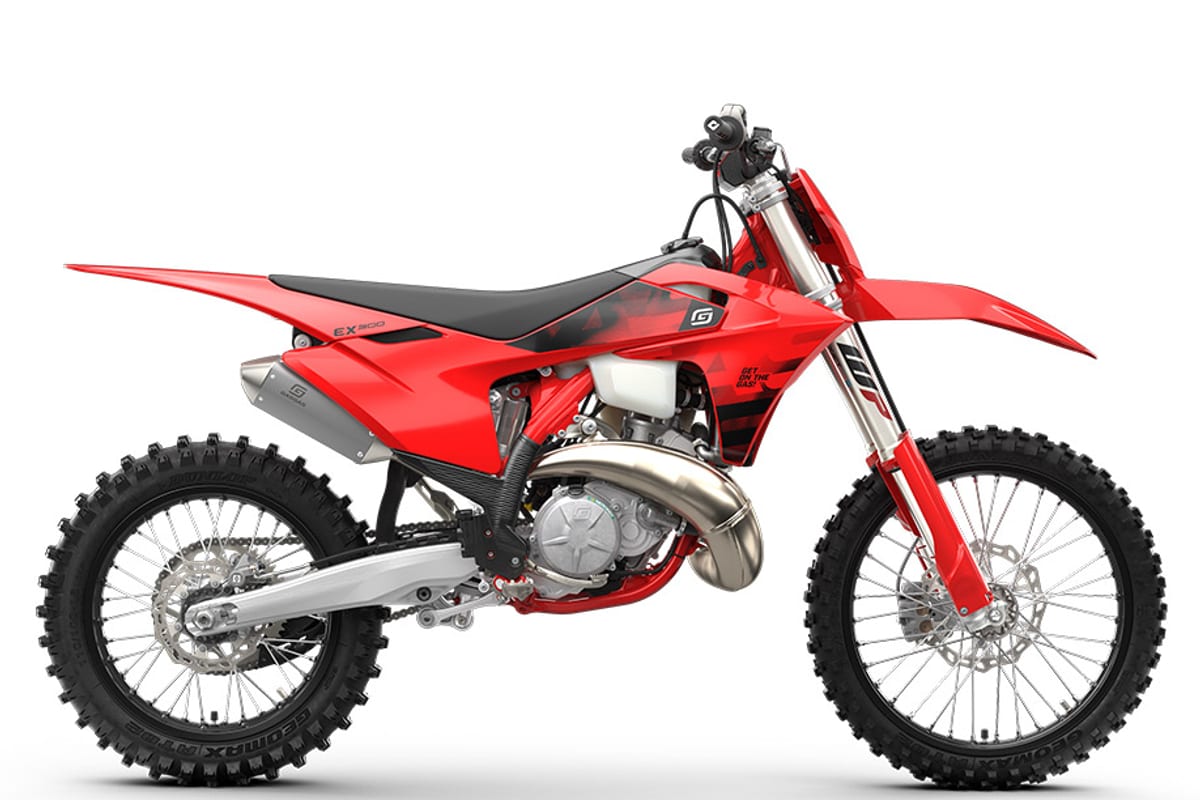2027 GasGas EX 300 cross-country two-stroke in red and black, right-side studio profile showing the tuned exhaust pipe and spoked wheels