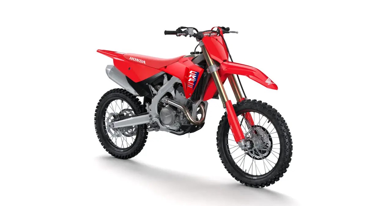 2027 Honda CRF250R motocross bike in red, right-side front three-quarter studio view showing gold forks and CRF graphics