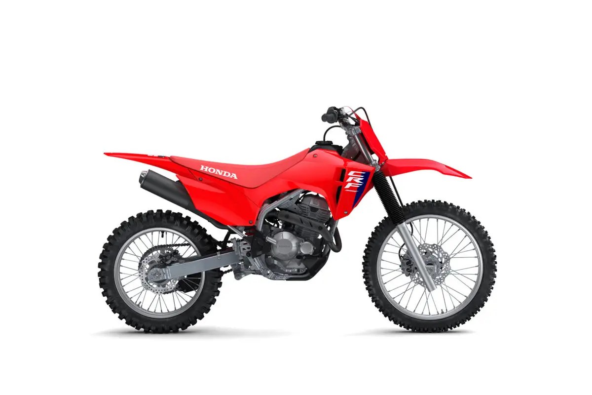 2027 Honda CRF300F trail bike in red with white CRF graphics, right-side studio profile showing the spoked wheels, single exhaust and inverted fork