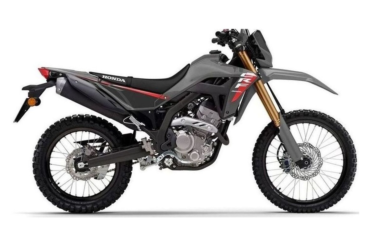 2026 Honda CRF300LS dual-sport motorcycle in gunmetal grey with red accents, left-side studio profile showing gold inverted forks and knobby tires