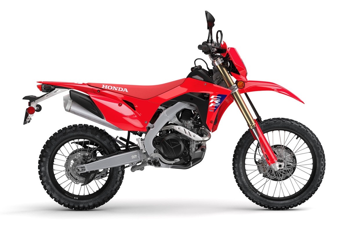 2027 Honda CRF450RL dual-sport in red, right-side studio profile showing the gold inverted forks, silver exhaust canister and spoked wheels