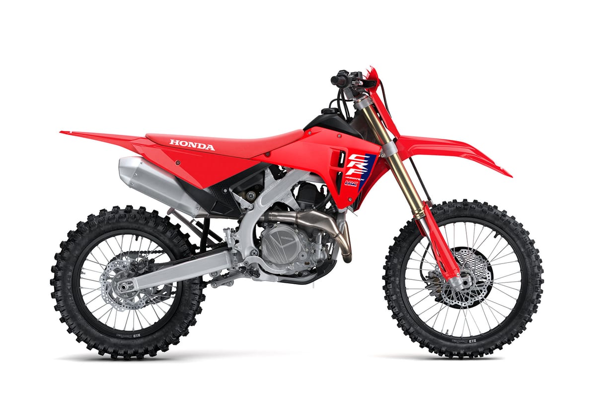 2027 Honda CRF450RX cross-country bike in red, right-side studio profile showing gold-coated forks, silver exhaust and knobby tires
