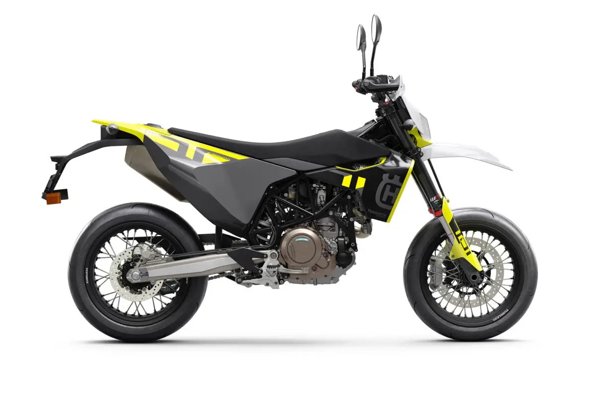 2026 Husqvarna 701 Supermoto in black and yellow, right-side studio profile showing the white front fender, spoked wheels and slip-on exhaust