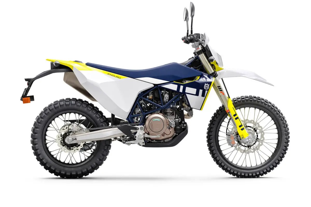 2027 Husqvarna 701 Enduro dual-sport in white, navy and yellow, right-side studio profile showing WP forks, spoked wheels and twin exhausts